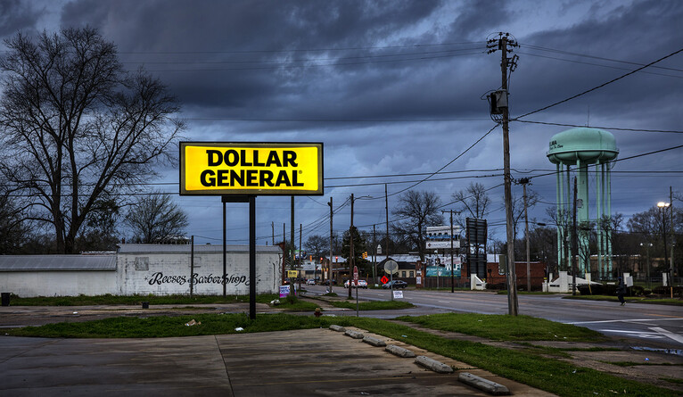 store sign for Dollar General on a road in town
