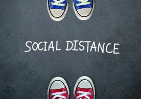 blue sneakers and red sneakers facing each other with "Social Distance" written in between
