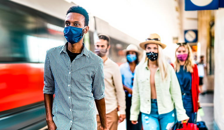 photo of people wearing masks in an airport